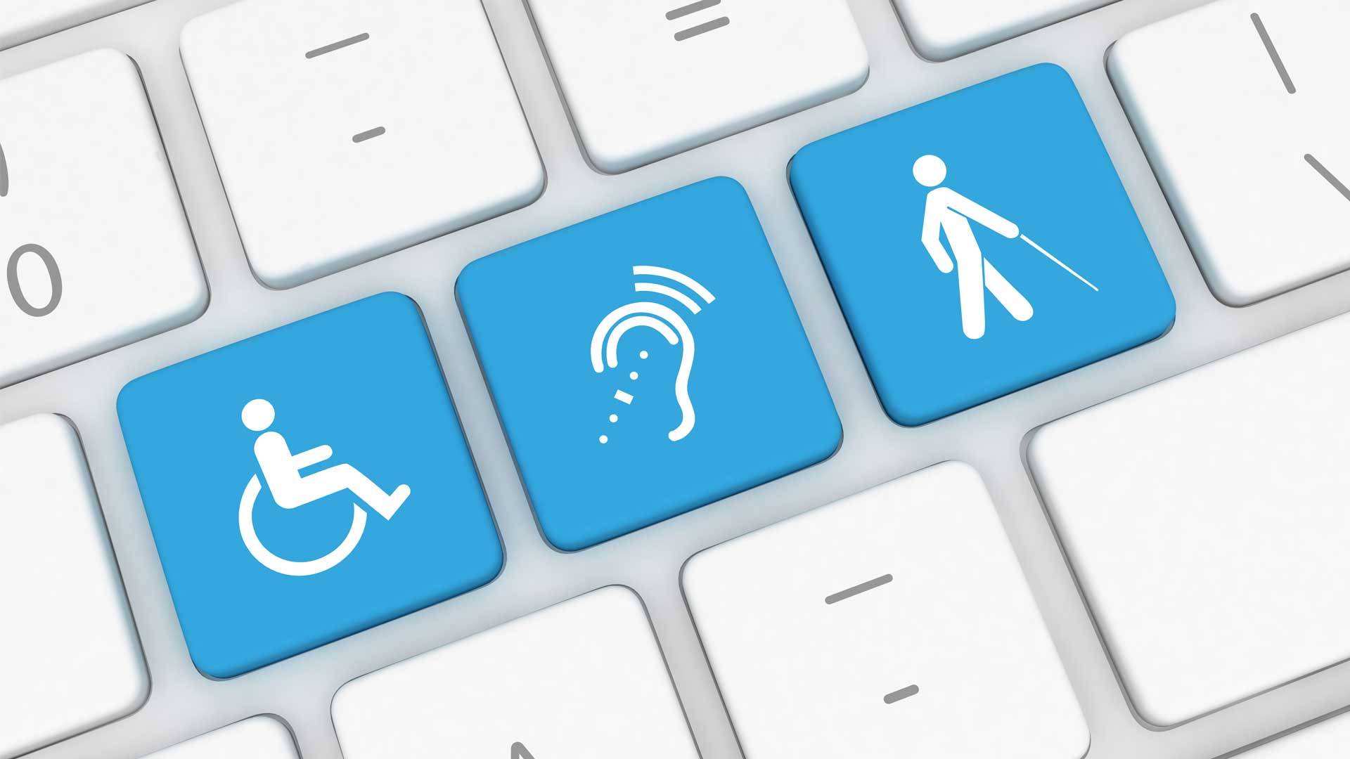 Ikone digitalne dostopnosti na tipkovnici – invalidski voziček, okvara sluha, slepota